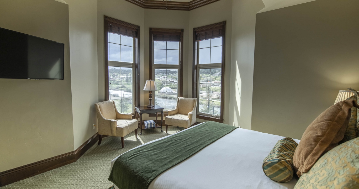 The Condo Suite bedroom with large windows placed in a curved wall